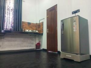 a kitchen with a stainless steel refrigerator in a room at silent beach House For Ever in Tangalle