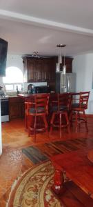 a kitchen with a table and chairs in a room at Summer Nights Oceanfront Villa - Pool & Jacuzzi in Primo Tapia