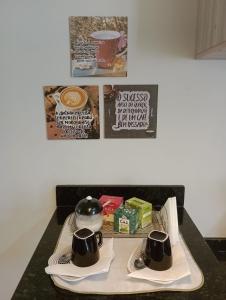 a table with two coffee cups on a tray at Casa aconchegante e completa em Osório - Ótima localização in Osório +9 photos