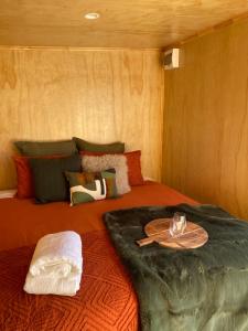 a bedroom with a bed with a tray on it at Ruapehu Views Cabin Getaway in Raetihi