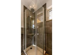 a bathroom with a shower and a sink at Bungalow im Campingpark in Waxweiler +28 photos