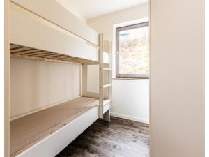 a room with two bunk beds and a window at Bungalow im Campingpark in Waxweiler