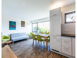 a kitchen and living room with a table and chairs at Bungalow im Campingpark in Waxweiler