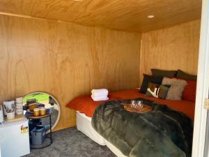 a small room with a bed and a table at Ruapehu Views Cabin Getaway in Raetihi