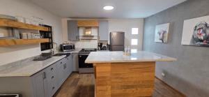 a kitchen with white cabinets and a counter top at Modern Industrial Artsy Apt Remodel Secure in Matamoros