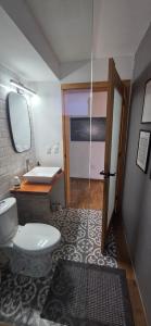 a bathroom with a toilet and a sink and a mirror at Modern Industrial Artsy Apt Remodel Secure in Matamoros +17 photos