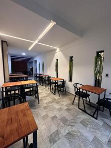 a dining room with wooden tables and chairs at LakeHouse Hotel & Suites in Villa Carlos Paz