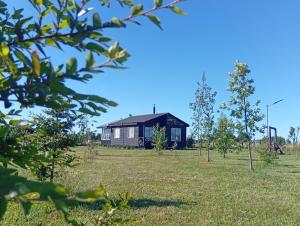a house in the middle of a field at Los Notros de Frutillar in Frutillar