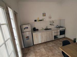 a kitchen with a refrigerator and a sink at Depto Civora 5 in Villa Regina