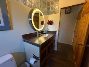 a bathroom with a sink and a mirror at High Moon 4 Ten Thousand Waves Way in Santa Fe