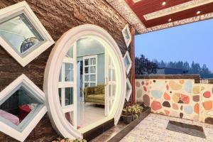 a house with a large mirror on the side of it at RedDoorz at Ingan Cio Homestay Berastagi in Berastagi +15 photos