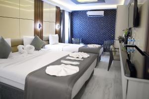 a hotel room with two beds with towels on them at AMARA OLD CITY HOTEL & Spa in Istanbul