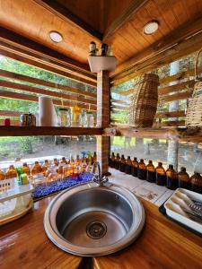 a bathroom with a sink and a counter with a window at Brisas del llaima in Melipeuco +95 photos