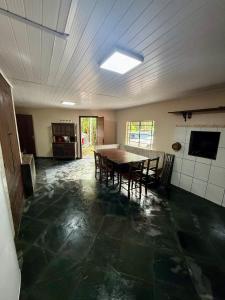 a kitchen with a table and chairs in a room at Sítio Castelo Branco - Morretes in Morretes