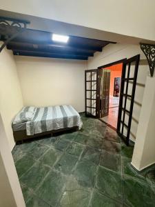 a bedroom with a bed in the corner of a room at Sítio Castelo Branco - Morretes in Morretes +22 photos
