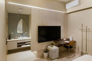 a bathroom with a television and a table in a room at Mr Petter in Taichung +25 photos