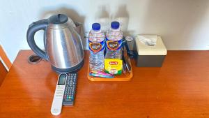 a table with two bottles of water and a blender at Sang Surya Guest House in Bandung +6 photos