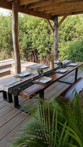 a wooden picnic table on a wooden deck at Villa Aïdo in Ouidah
