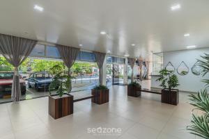 a mall with potted plants and a car dealership at 1-Bedroom Apt in Blumenau SPN0102 in Blumenau