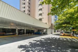 a parking lot with cars parked in front of a building at 1-Bedroom Apt in Blumenau SPN0102 in Blumenau