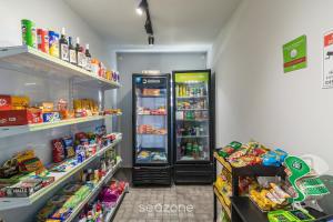 a grocery store aisle with two refrigerators and food at 1-Bedroom Apt in Blumenau SPN0102 in Blumenau