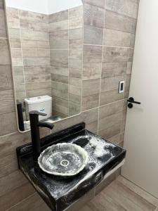 a bathroom with a sink and a mirror at LakeHouse Hotel & Suites in Villa Carlos Paz +38 photos