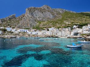 a group of boats in a body of water with buildings at Casa del Clown in Trapani