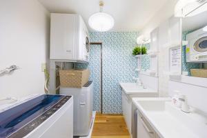 a kitchen with white appliances and blue tiles at -Shibamata House- 9-minute walk from Shibamata Station in Tokyo
