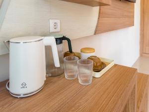 a kitchen counter with glasses and a blender on it at Airindah Villa in Gili Islands