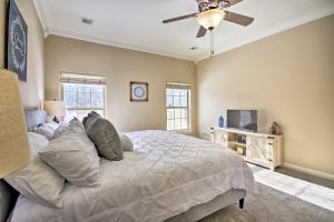 a bedroom with a bed and a ceiling fan at The Hub in Bella Vista