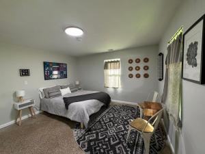 a bedroom with a bed and a table and chairs at The Holler in Andrews