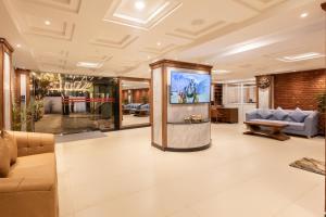 a living room with a large screen in the center at Tulsi Kathmandu Hotel in Kathmandu