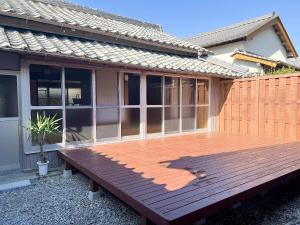 a wooden deck in front of a house at いなかじかん in Yasuda