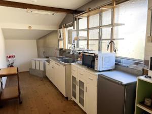 a kitchen with a microwave and a sink at いなかじかん in Yasuda +31 photos