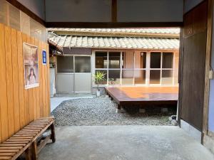 a patio with a wooden table in front of a building at いなかじかん in Yasuda