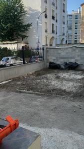a fire hydrant in a parking lot next to a building at Nineja in Fontenay-sous-Bois