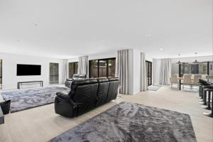 a large living room with a couch and a television at 44b Scarborough Terrace in Hanmer Springs