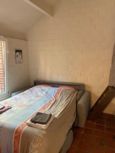 a bedroom with a bed with a blanket on it at Chalet cosy - terrasse et détente, escapade nature au Bonsoy in Waulsort