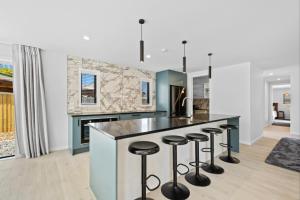 a kitchen with a large island with bar stools at 44b Scarborough Terrace in Hanmer Springs