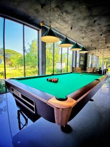 a billiard table in a room with a green at Catch Up Dambulla in Dambulla