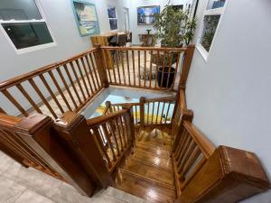 a wooden staircase with a glass floor in a room at BethsAida Conference Center & Boutique Accommodations in Simpson Bay