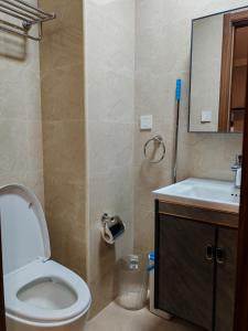 a bathroom with a toilet and a sink and a mirror at Raya's Staycation Megatower 7 Baguio City in Baguio +10 photos