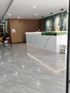 a lobby with a white table and a sign that reads meetings meeting at Raya's Staycation Megatower 7 Baguio City in Baguio