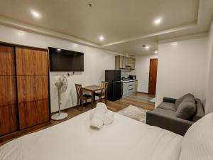 a bedroom with a bed and a living room at Raya's Staycation Megatower 7 Baguio City in Baguio