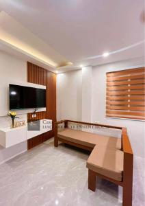 a living room with a large flat screen tv at Lia Clarke Transient House in Nasugbu