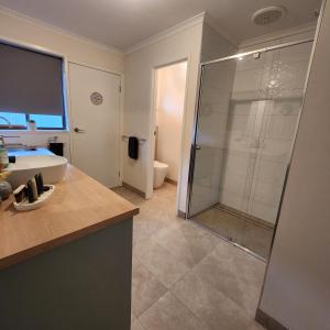 a bathroom with a shower and a sink at LBarza 1BR CBD Self Contained Apartment in Shepparton +9 photos