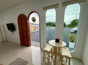 a room with a table and chairs and a window at Farinda Resort in Phangnga
