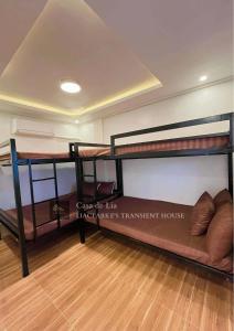 a room with two bunk beds and a couch at Lia Clarke Transient House in Nasugbu