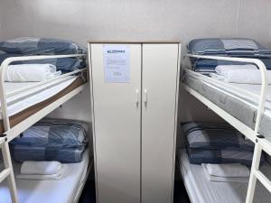 a room with two bunk beds with a sign on it at Paynesville Holiday Park in Paynesville +5 photos
