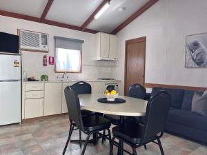 a kitchen and dining room with a table and chairs at Paynesville Holiday Park in Paynesville